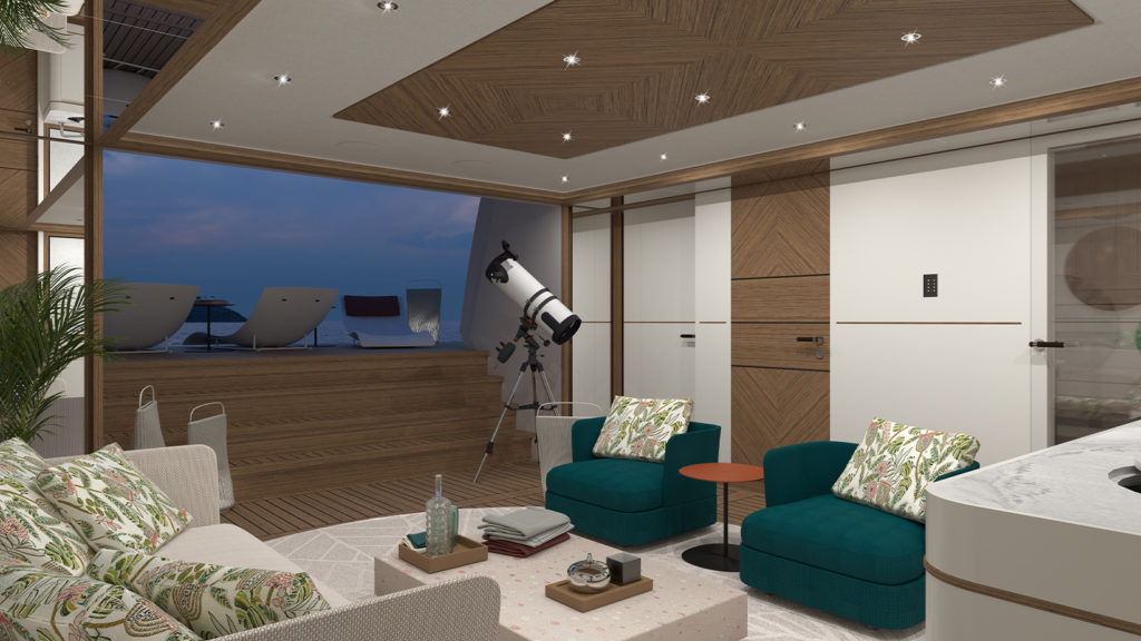 Luxurious interior living space with turquoise chairs and a floral sofa, featuring a telescope by a glass door leading to a deck with chaise lounges overlooking the sea.